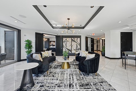 Resident lounge with two black couches at Dominion Post Oak apartments in Houston, TX